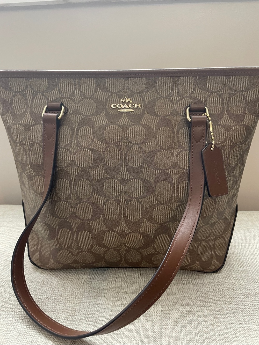 Coach shoulder bag in signature coated canvas. Tan and brown.